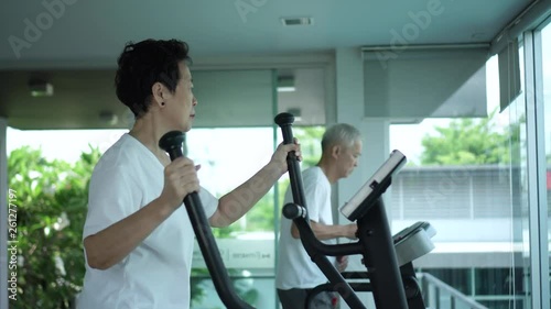 Asian senior couple exercise together in modern luxury reacreation wellness gym photo