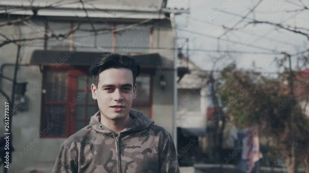 Young man smiling and looking at camera. Portrait of a happy handsome young man outdoor. Close up face of young cool trendy man looking at camera. Young man smiling and looking at camera. Portrait of a happy handsome young man outdoor. Close up face of young cool trendy man looking at camera.