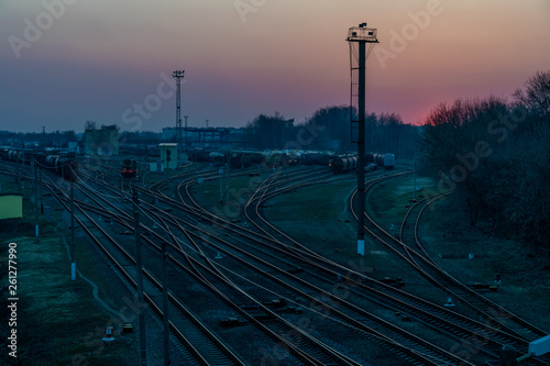Railway tracks with freight trains in the evening after sunset