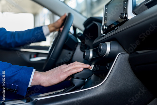 Male hands on steering wheel, car interior © RomanR