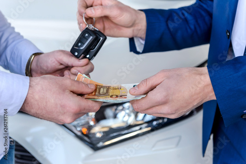 Male hands exchanging with euro and car keys
