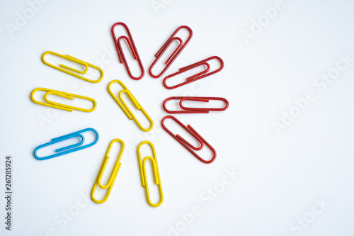 colored clips scattered on white background, form some pattern