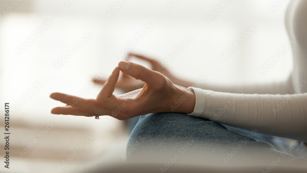 Close up peaceful woman sitting in lotus pose and meditating