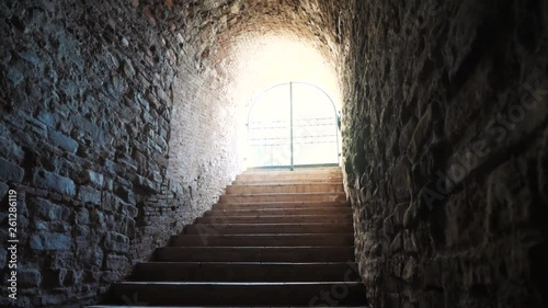 Medieval cellar with stairs going out to the light in an old medieval castle.