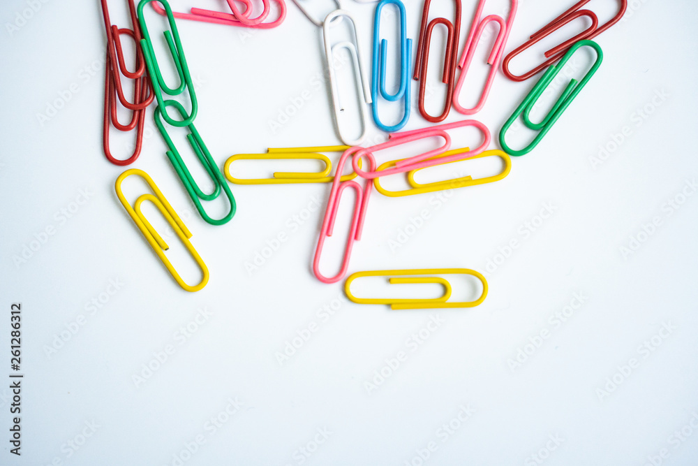 colored clips scattered randomly on white background colored clips scattered randomly on white background