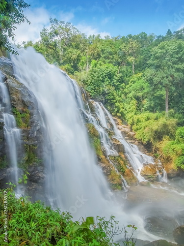 Wachirathan Waterfalls  beautiful waterfall flowing from high cliff around with green forest and blue sky background  Doi Inthanon National Park  Chiang Mai  northern Thailand.