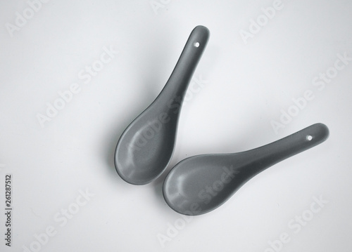 grey color chinese spoon made of ceramics，isolated in white background