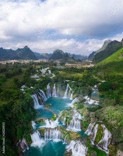 Massive hidden waterfall surrounded by mountain with blue clean water. Paradise on the border between China and Vietnam. Ban gioc waterfall, Detian. 
