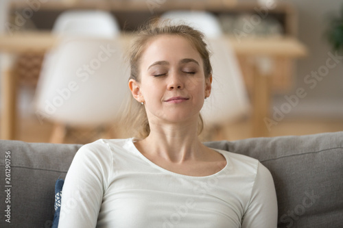 Free Download Close up calm peaceful woman relaxing with closed eyes on sofa - GFXLoad