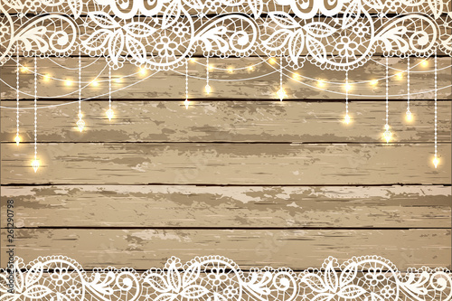 Wedding invitation card. Beautiful lace with decorative lights for party. Vintage wooden background. Inspiration card for wedding, date, birthday, tea or garden party