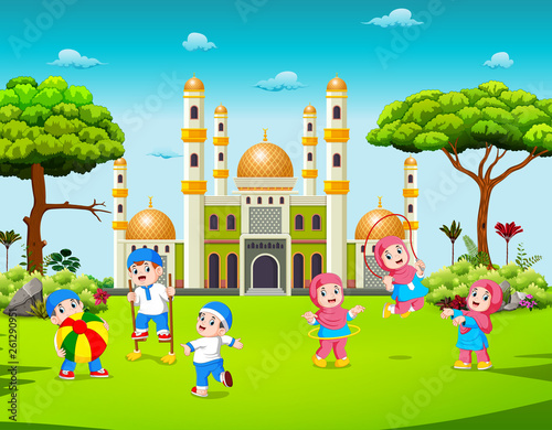 the children are playing in the yard near the mosque 