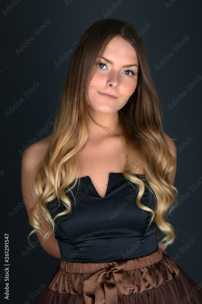 Beautiful smiling woman with clean skin, natural make-up, and white teeth on grey background Beautiful smiling woman with clean skin, natural make-up, and white teeth on grey background