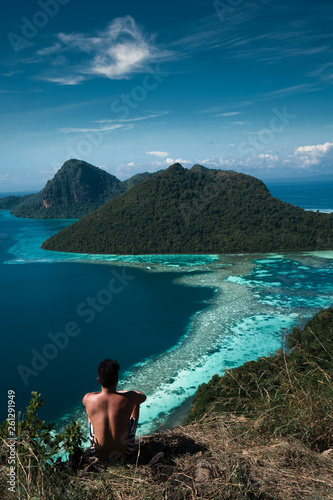 Amazing tropical paradise islands from the air with blue turquoise blue lagoon water and coral reef. Aerial view of Bohey Dulang island panorama. Hawaii, Philippines, French polynesia.
