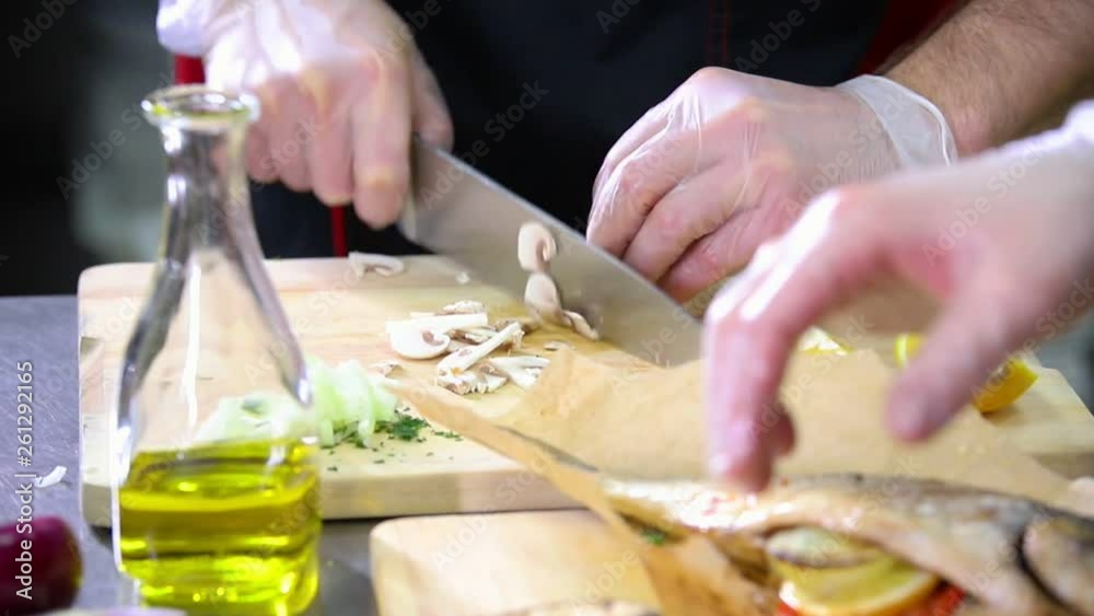 A chef working in the kitchen. Cutting the mushrooms A chef working in the kitchen. Cutting the mushrooms