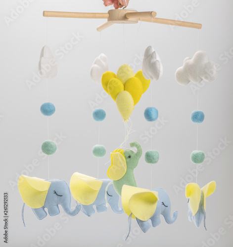 Colorful and eco-friendly children's mobile from felt for children. On grey background.