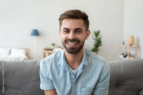 Head shot portrait of smiling man looking at camera, video call