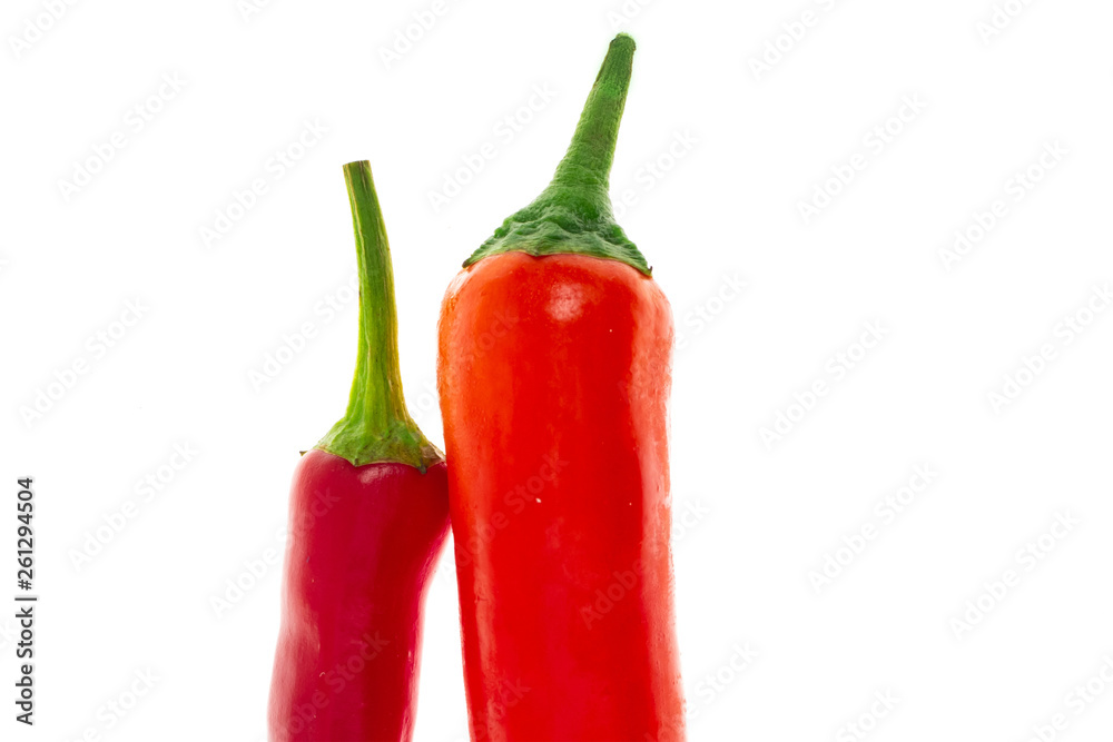 mature red pod pepper couple of vegetables green stalk close-up on white background