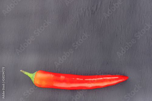 dark base black slate restaurant design copy space with red chili pepper pod contrast vegetable