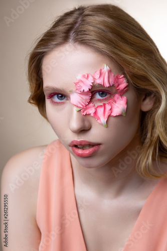 Professional model working showing poses with petals on face