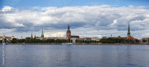 Panoramic view across river of old town in Riga, Latvia with clouds in sky