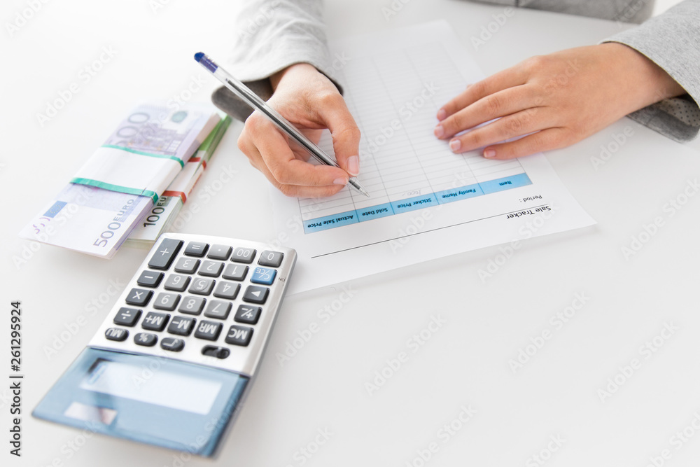 business and finances concept - close up of businesswoman with tax form, calculator and money on office table business and finances concept - close up of businesswoman with tax form, calculator and money on office table