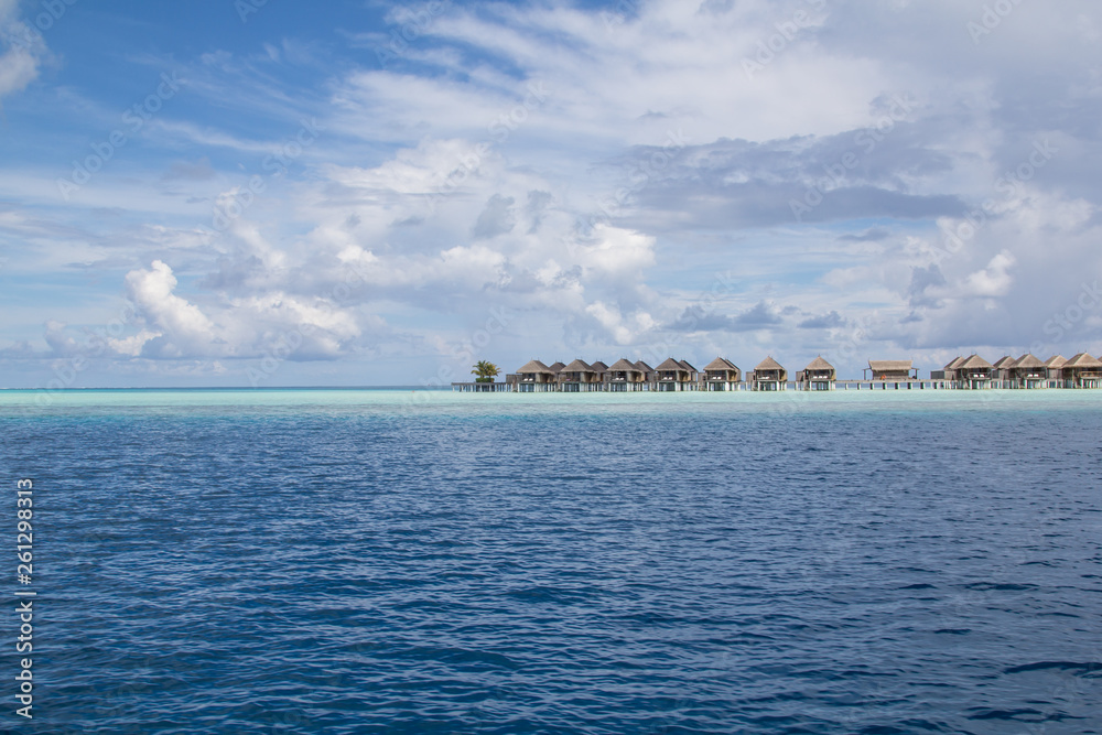 Seaside wooden bungalows on a shallow reef in a luxury resort in the atoll of the Maldives	threatened by climate change