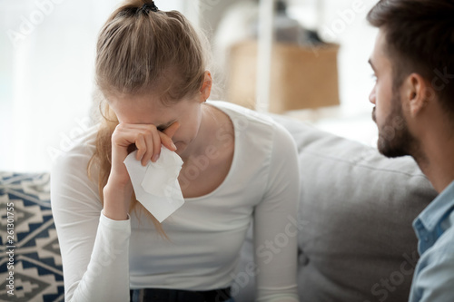 Canvas Unhappy couple, woman with handkerchief crying, relations problem