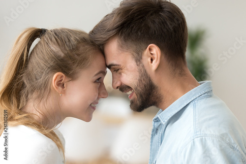 Close up smiling couple in love touching forehead, enjoying tender moment