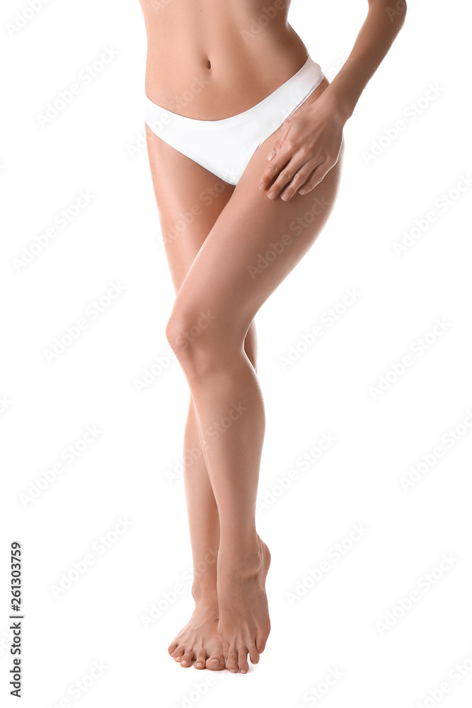 Beautiful young woman after epilation of legs on white background