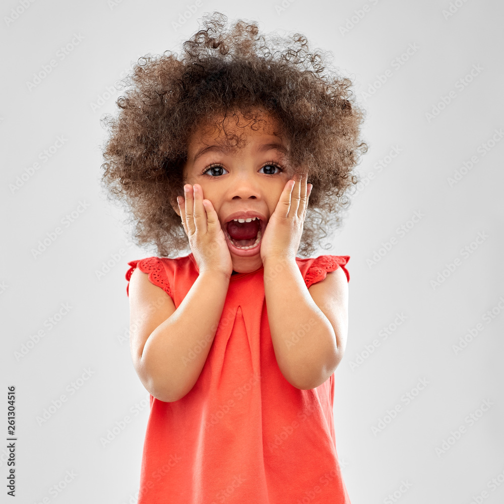 childhood and people concept - surprised or scared little african american girl screaming over grey background - obrazy, fototapety, plakaty 