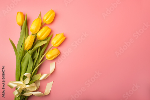 Spring card: yellow tulips on a coral background. Top view, lay flat © Tanee