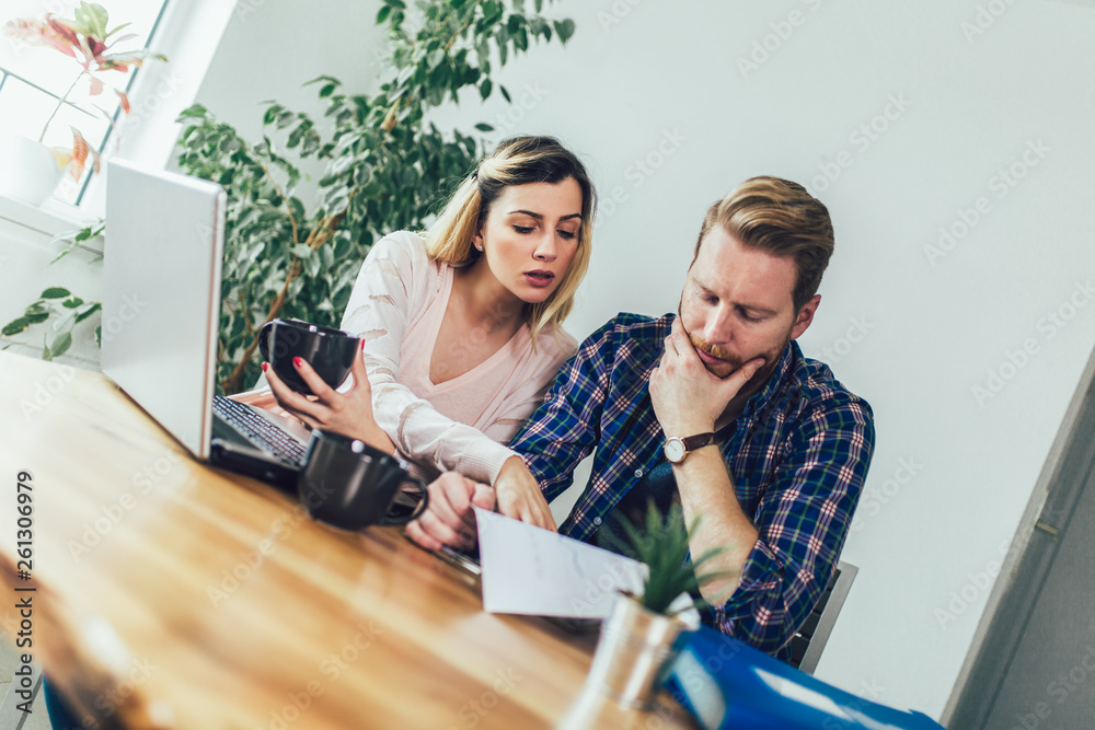 Woman and man doing paperwork together, they report online tax on the laptop. Woman and man doing paperwork together, they report online tax on the laptop.