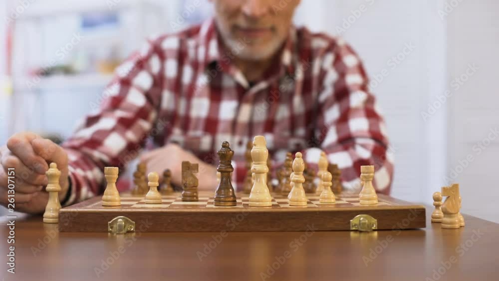 Senior gentleman training for chess competition, developing strategy, checkmate