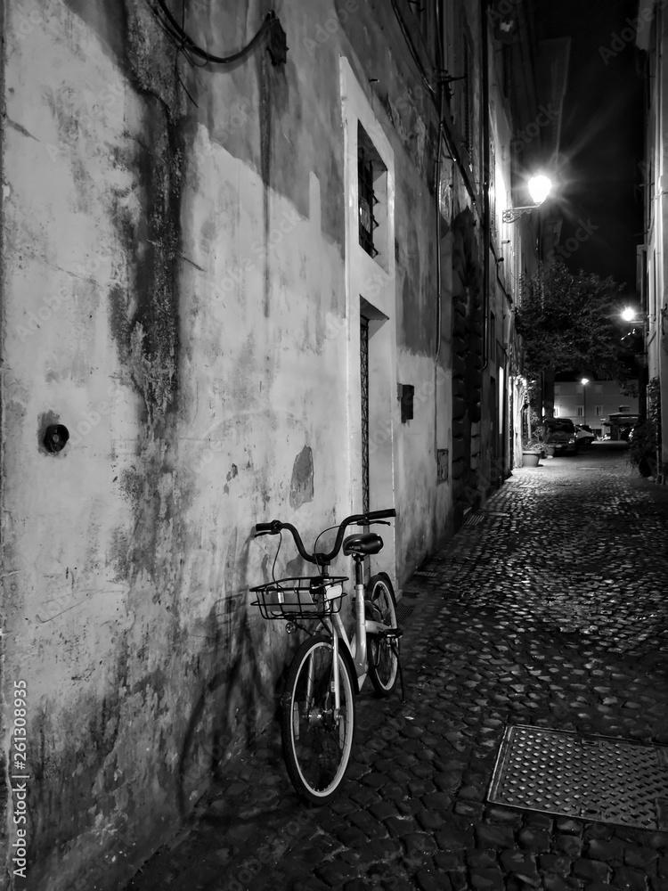 Old classic bicycle by an ancient city wall in rome historical street