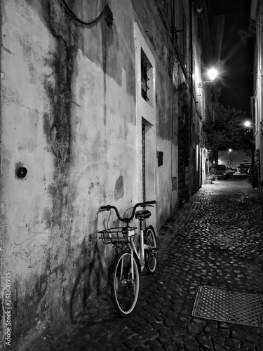 Old classic bicycle by an ancient city wall in rome historical street
