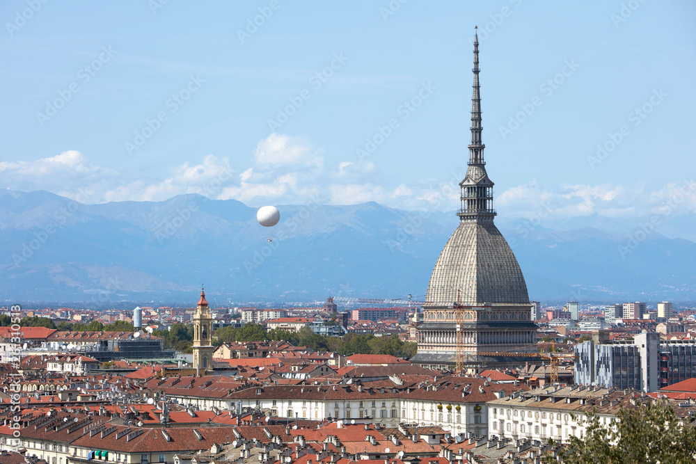Turin skyline view, Mole Antonelliana tower and hot air balloon in a sunny summer day in Italy