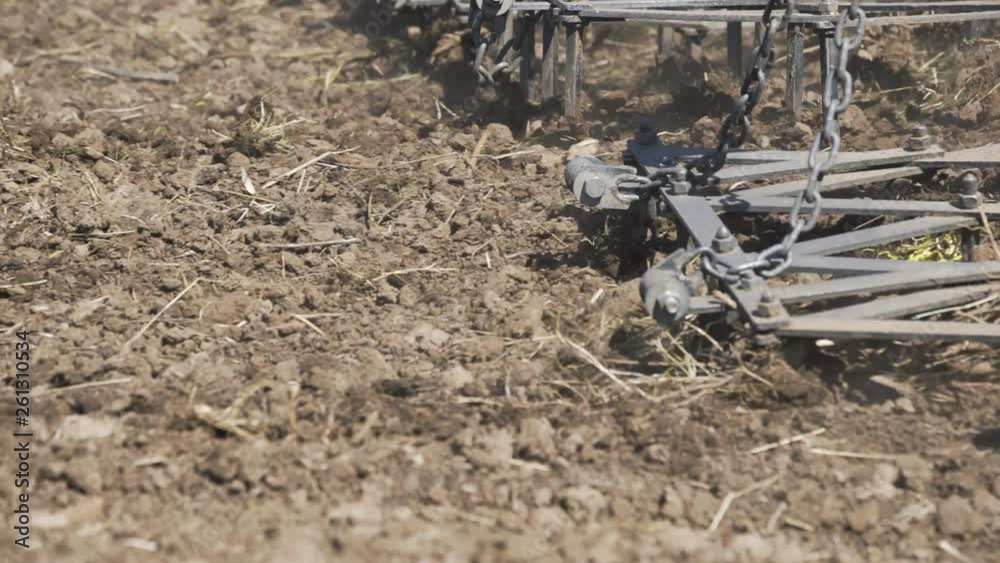 Tractor plows field with plows before sowing. Agricultural machinery on plowing field Tractor plows field with plows before sowing. Agricultural machinery on plowing field