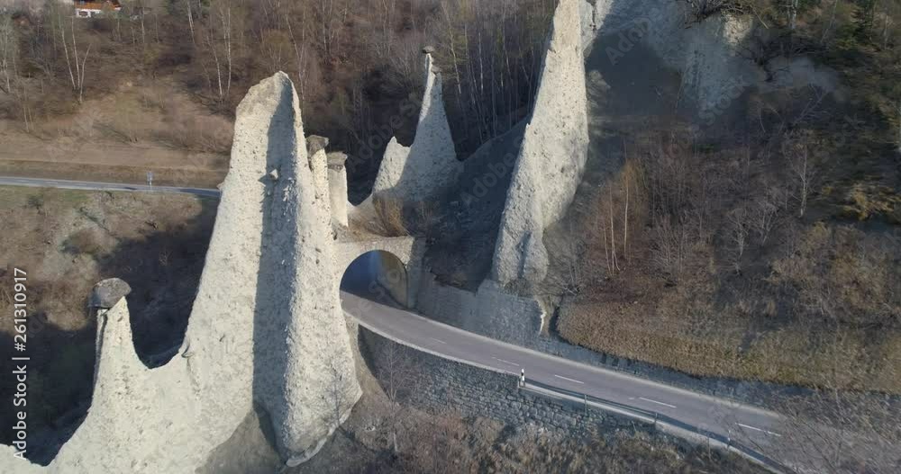 Car pass under Euseigne Pyramides - Aerial 4K