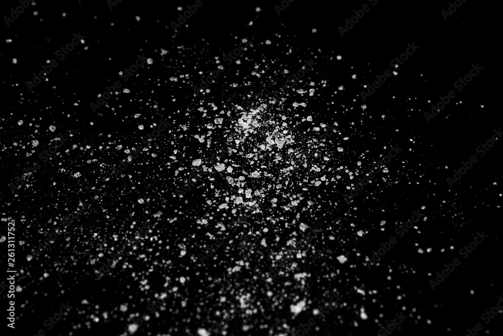 white crystalline powder on a black background. sugar dust 