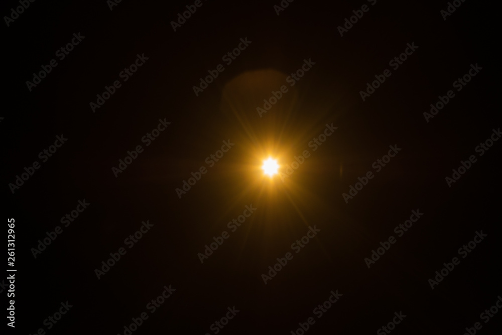 Single spark on black background. Lens flare effect. Defocused rays and lights. Single spark on black background. Lens flare effect. Defocused rays and lights.