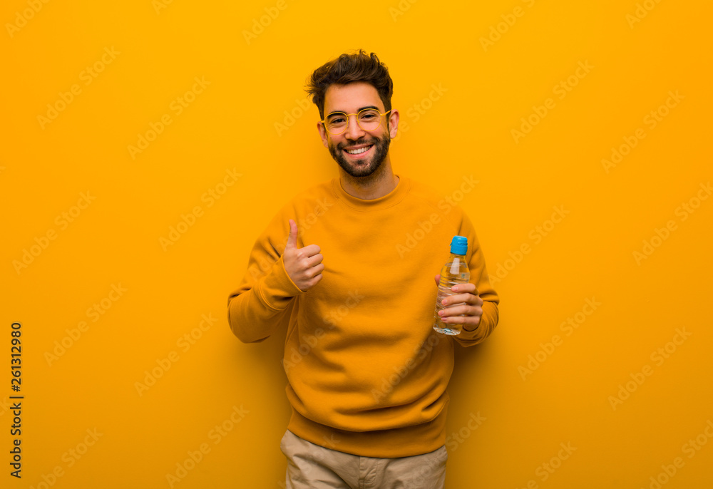 Young man smiling and raising thumb up Young man smiling and raising thumb up