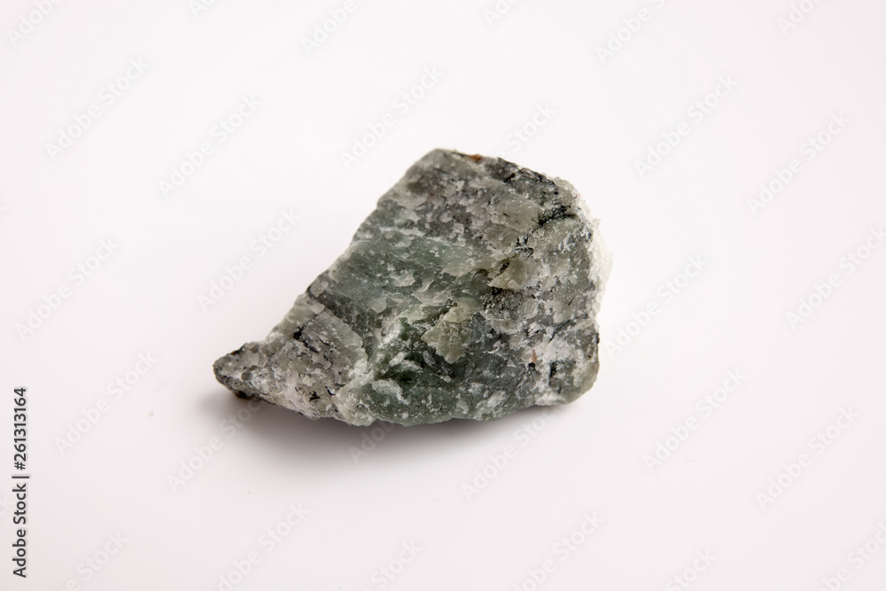macro photography of natural mineral from geological collection - raw green Nepheline rock with black Ilmenite stone macro photography of natural mineral from geological collection - raw green Nepheline rock with black Ilmenite stone