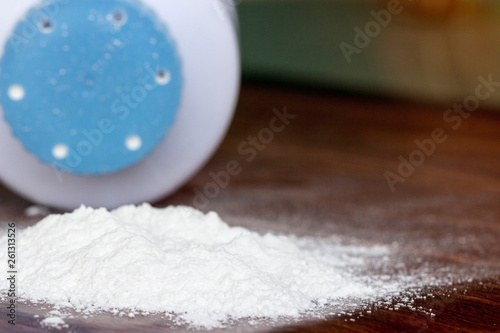 Baby talcum powder container on wooden background