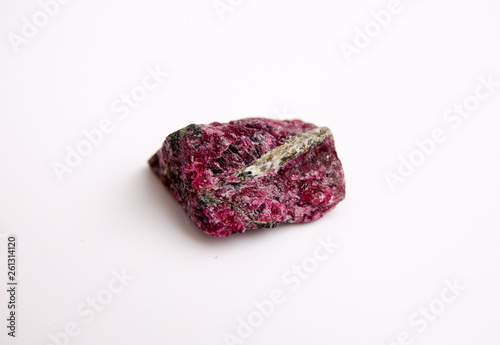 Natural rock specimen of eudialyte, a rarity minor gemstone, in nepheline syenite Kola peninsula, isolated on a white photo