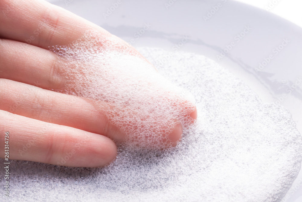 Hand with foam from dish detergent