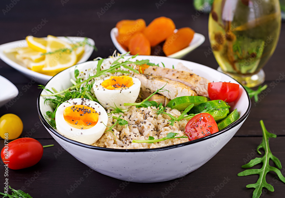 Fresh salad. Breakfast bowl with oatmeal, chicken fillet, tomato, lettuce, microgreens and boiled egg. Healthy food. Vegetarian buddha bowl. Fresh salad. Breakfast bowl with oatmeal, chicken fillet, tomato, lettuce, microgreens and boiled egg. Healthy food. Vegetarian buddha bowl.