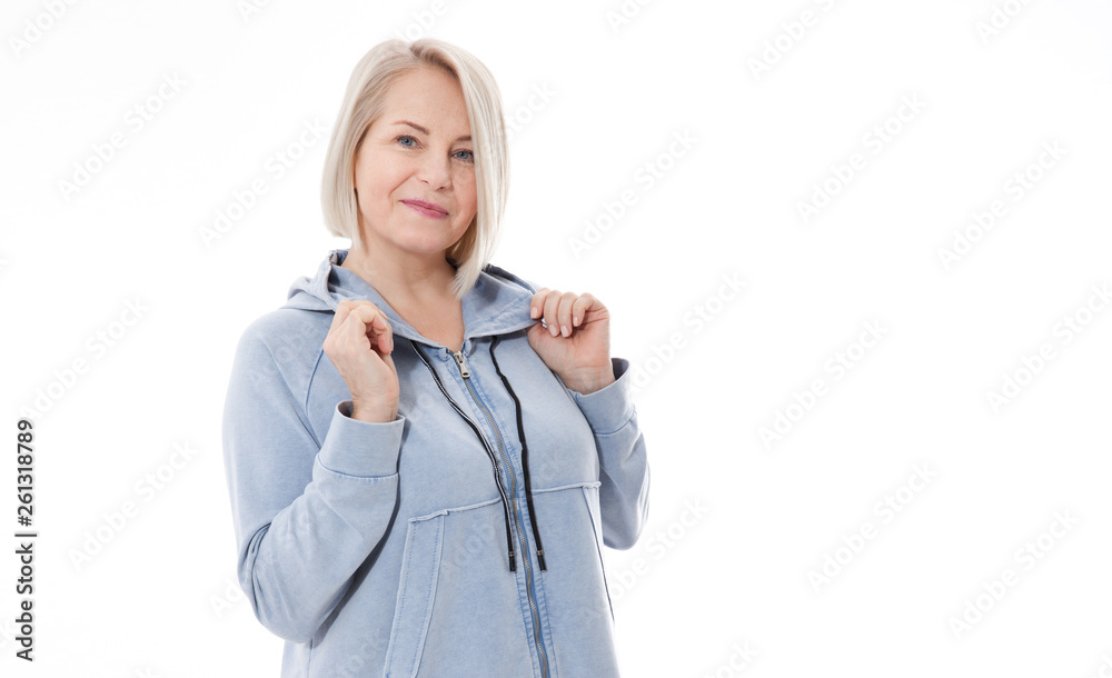 Middle aged blonde emotionally posing in a studio. Happy woman in yellow bright sweater on white background Middle aged blonde emotionally posing in a studio. Happy woman in yellow bright sweater on white background