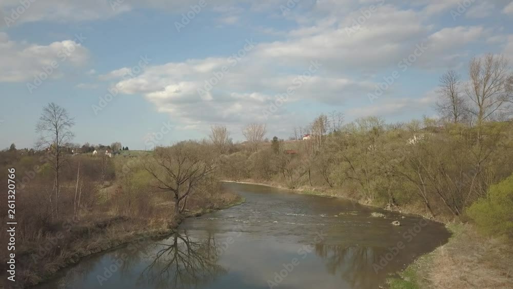A shallow mountain river flows among stones and lush greenery over the plain. Clear water and beautiful nature for rest and relaxation in the reserve. Fishing in the ecosystem of temperate climate. A shallow mountain river flows among stones and lush greenery over the plain. Clear water and beautiful nature for rest and relaxation in the reserve. Fishing in the ecosystem of temperate climate.