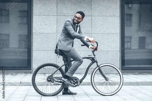 Businessman riding bicycle to work in morning