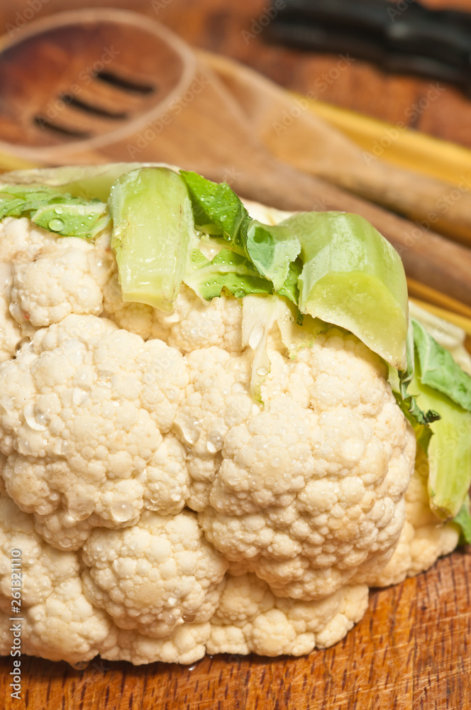 Front view, close up of a freshly picked head of cauliflower on display and for sale at a tropical farmers market vegetable Front view, close up of a freshly picked head of cauliflower on display and for sale at a tropical farmers market vegetable